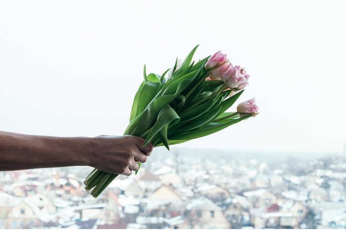 A person holding a bouquet of flowers.
