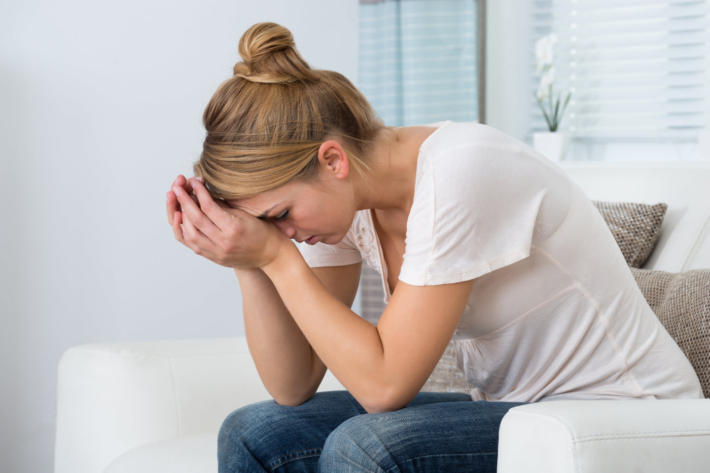 Woman with hands on head.