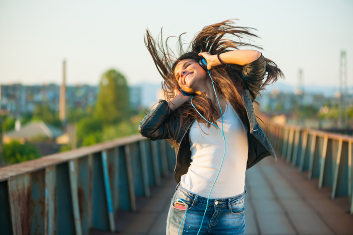 A person feeling good while listening to music after taking supplement for good mood.