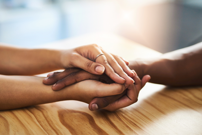 Two people holding hands.