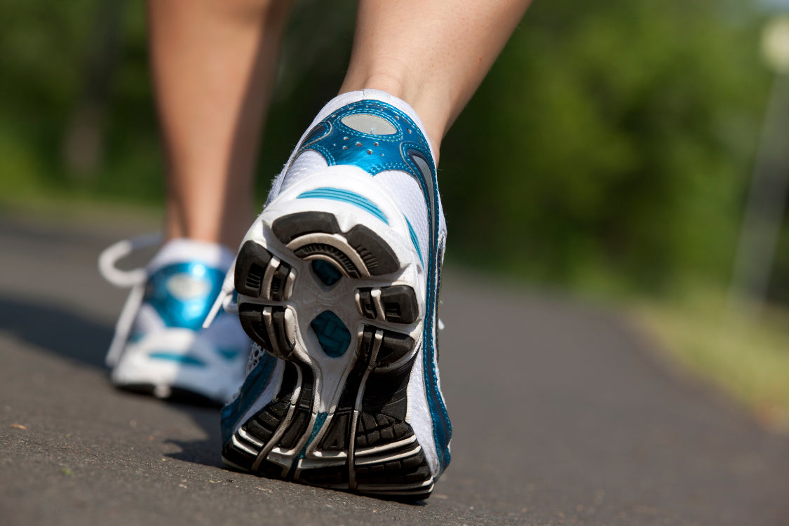 Close up of shoes during walking for stress relief outdoors
