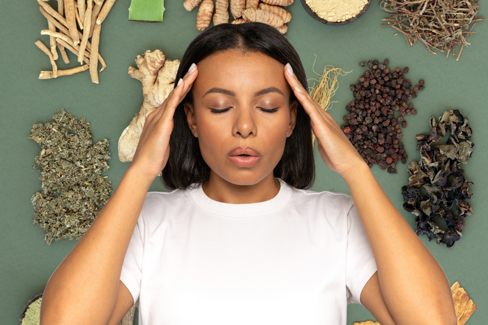 Woman practicing relaxation surrounded by adaptogens for stress herbs.