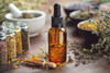 Woman inhaling essential oil bottle during aromatherapy for anxiety