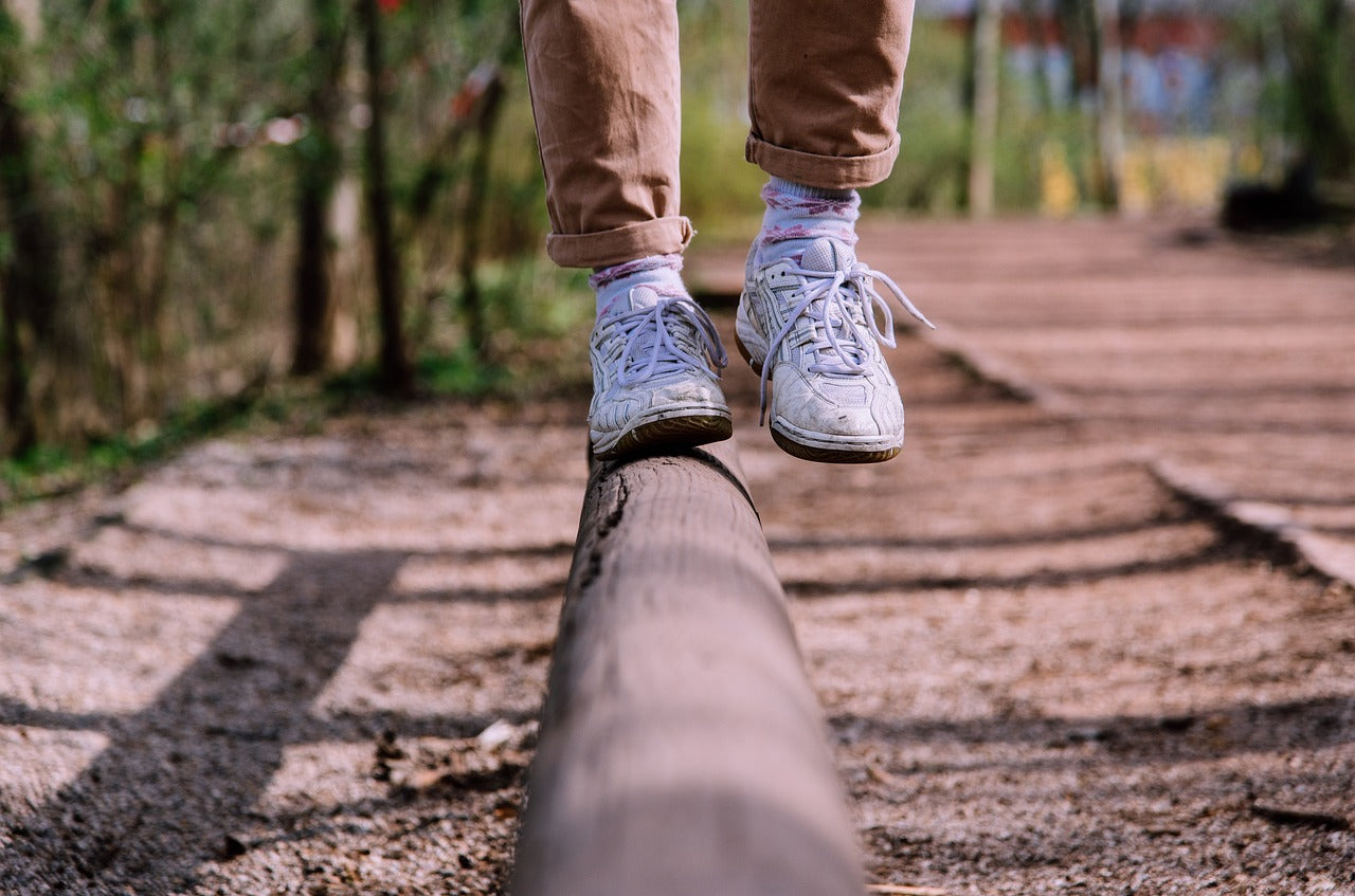 Person balancing on log