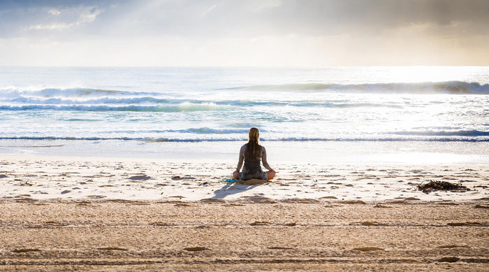 woman on beach reflecting life, relationships, and emotions