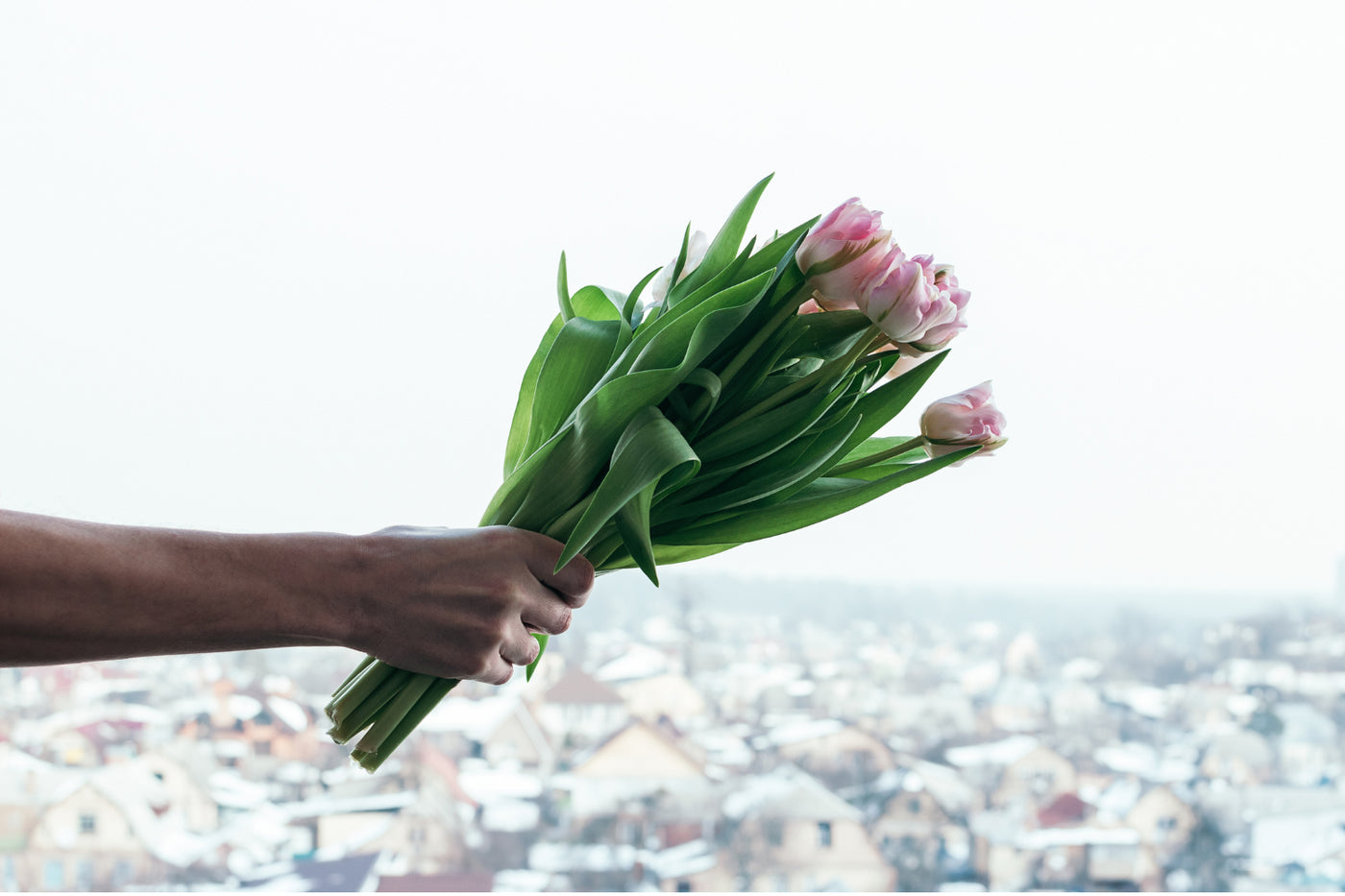A person holding a bouquet of flowers.