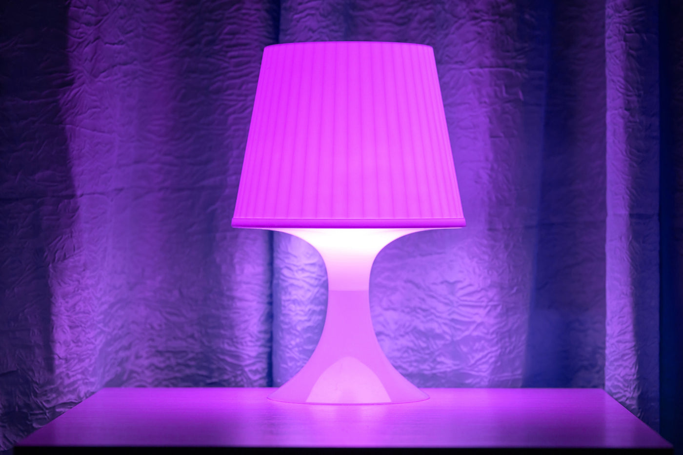 A purple lamp on the table.