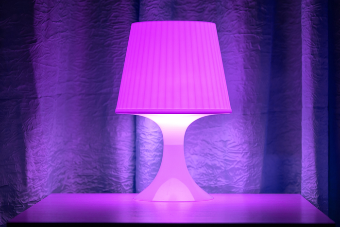 A purple lamp on the table.