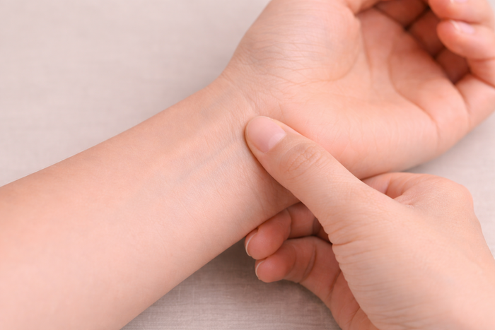 Thumb presses the wrist.