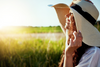 Woman smiling while facing the sun.