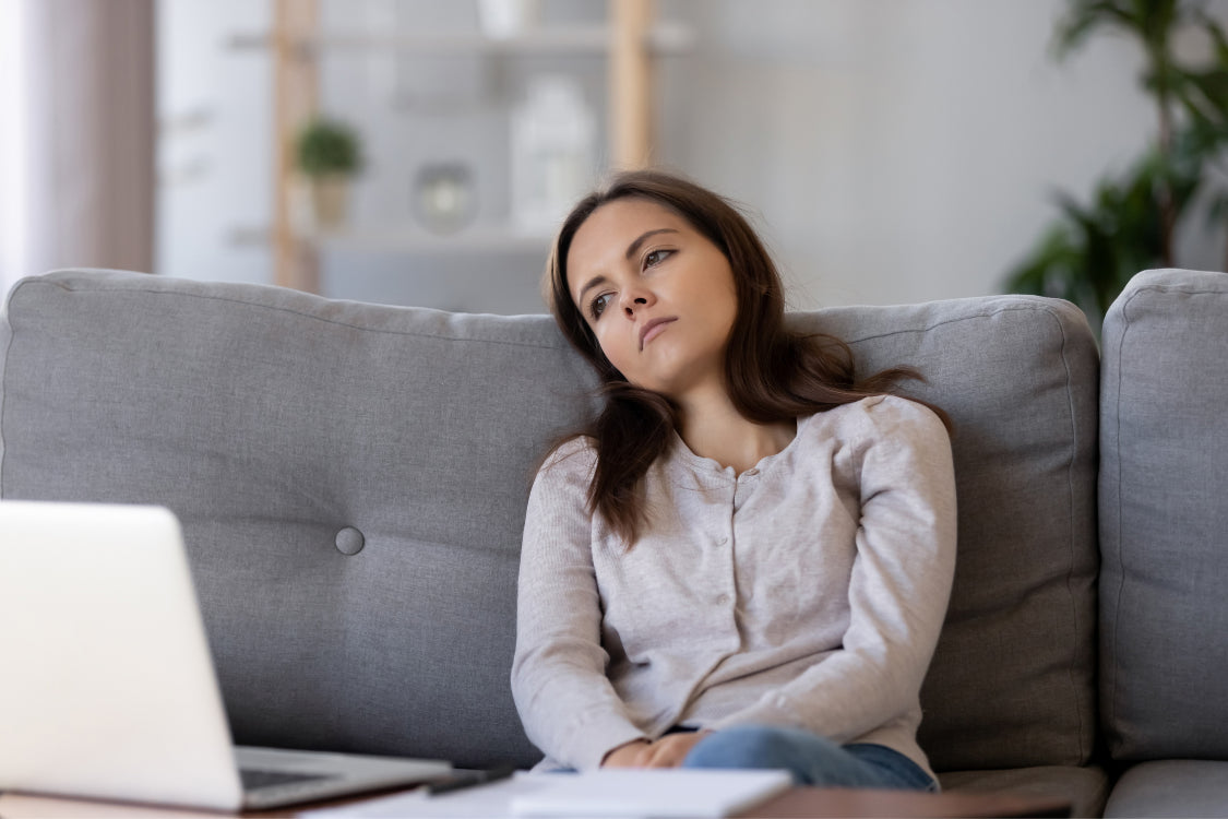 Woman experiencing fatigue and low mood, common symptoms of serotonin deficiency
