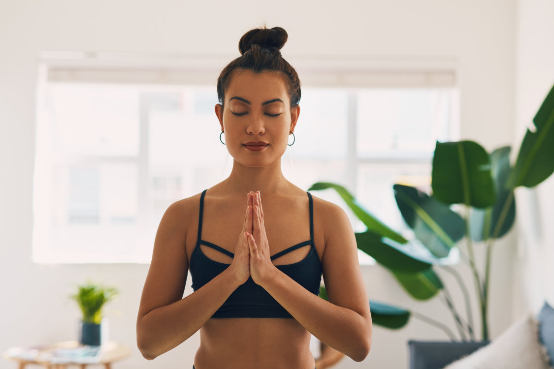 Woman practicing meditation to reduce stress and support serotonin balance
