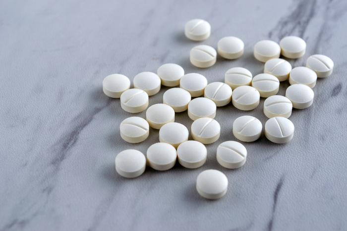 White melatonin tablets representing melatonin 3 mg sleep support supplements.