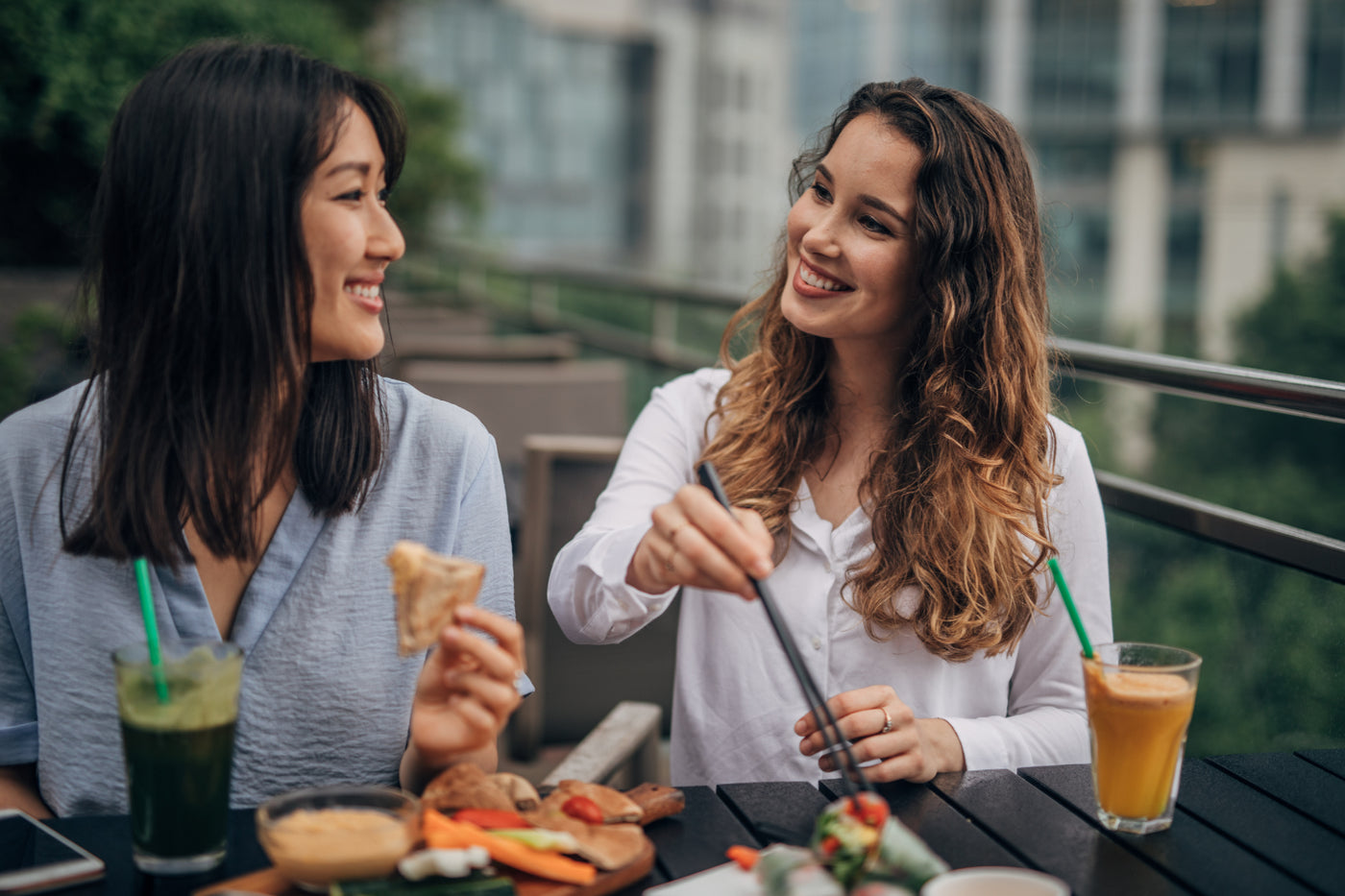 Two friends talking and eating healthy food.