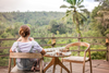 Woman looking at nature while sipping coffee.