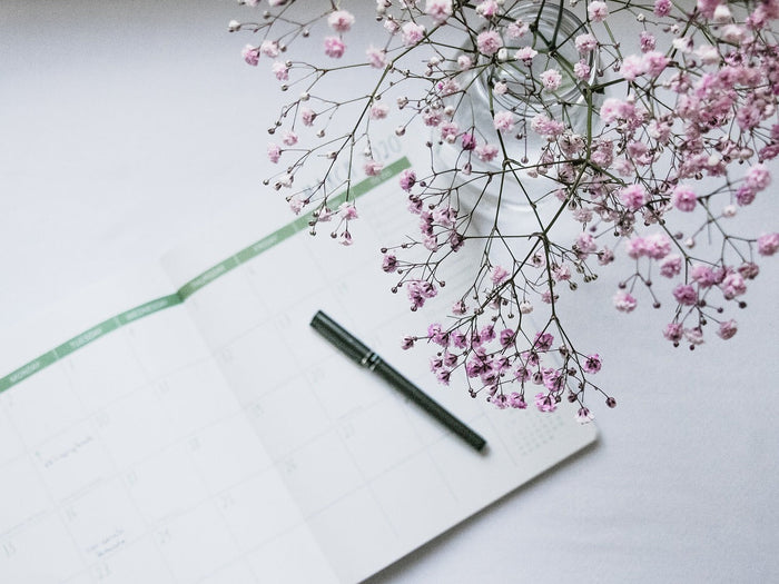Planner with pen and flowers