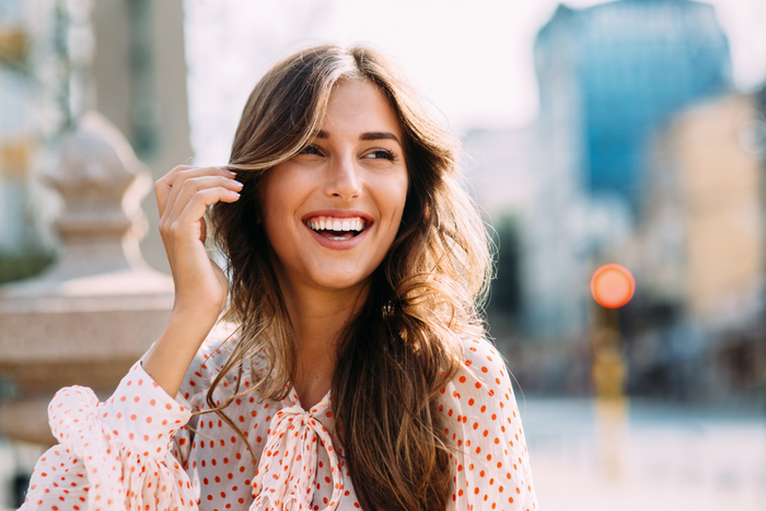 Woman smiling outdoors showing natural mood boost and happiness