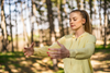 A woman practicing tai chi in a serene outdoor setting.