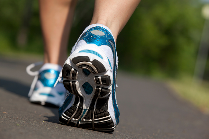 Close up of shoes during walking for stress relief outdoors